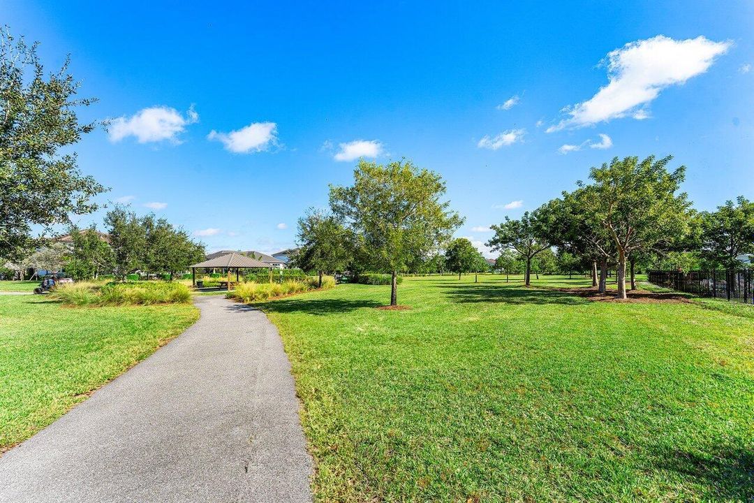 Lush corner-lot walkway with trees