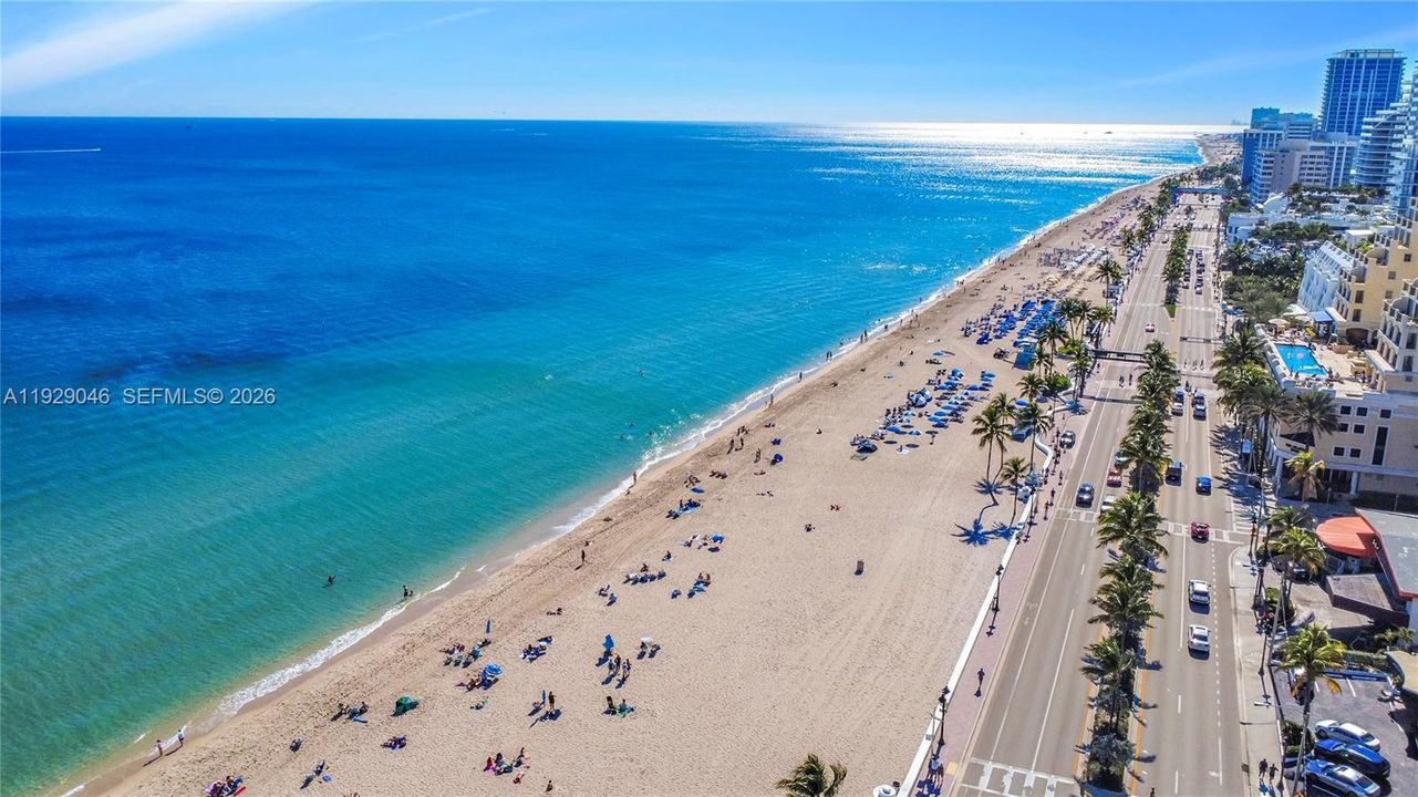 Step out to your private oceanfront retreat, complete with elegantly arranged chairs and umbrellas