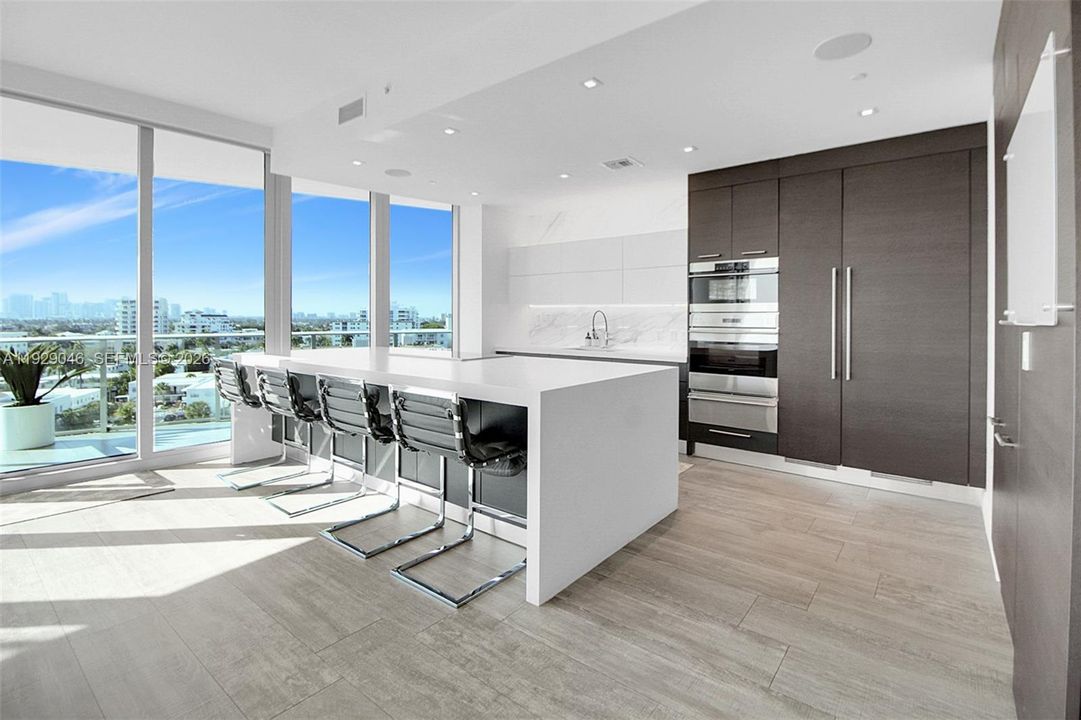 STUNNING ITALIAN WARM, SLEEK CHEFS KITCHEN WITH TOP OF THE LINE APPLIANCES