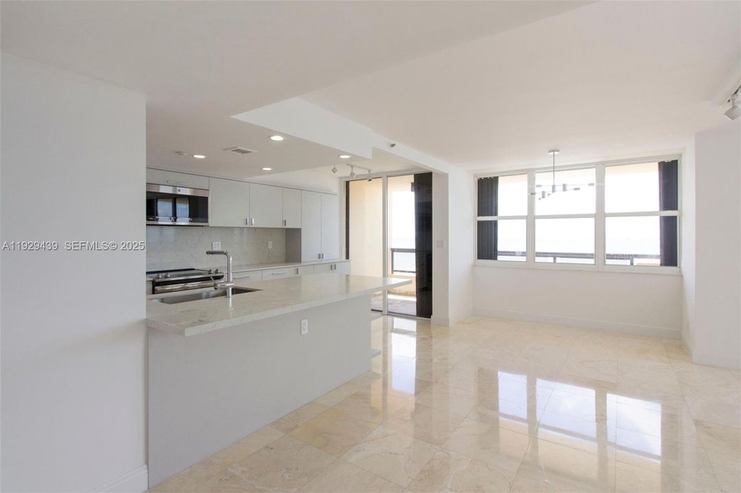 Open kitchen, living room, gleaming marble floors