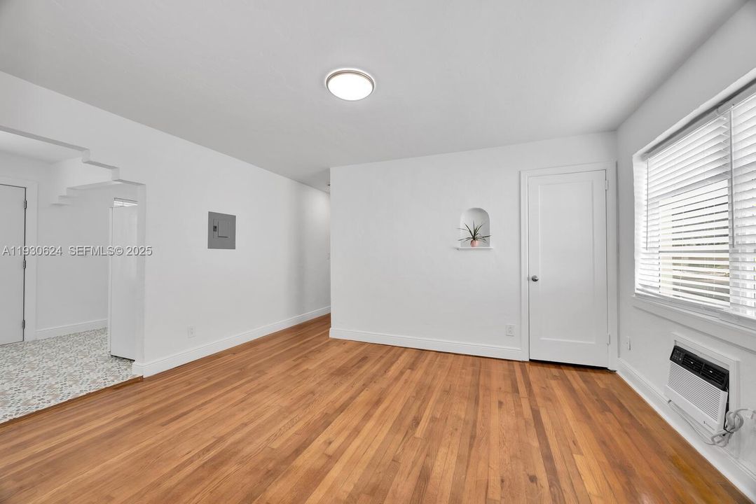 Living area. Plenty of light. Three window unit air conditioners.