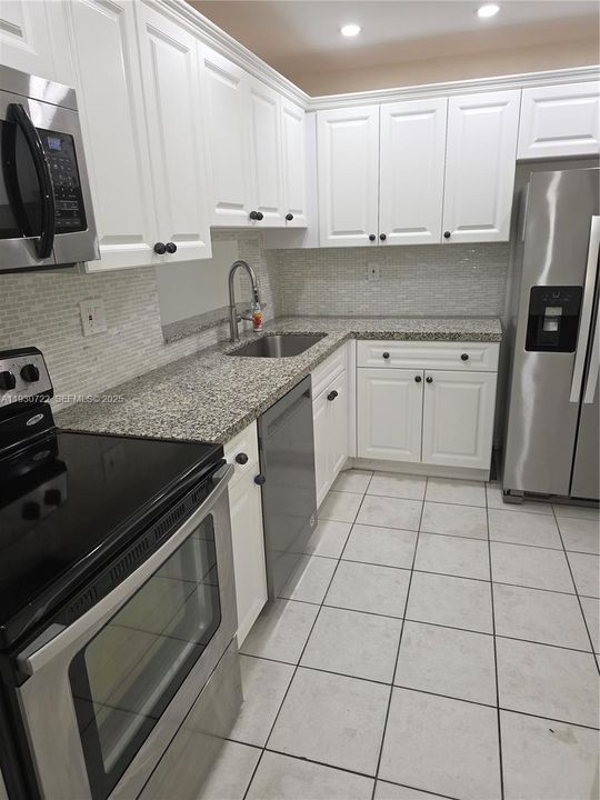 REMODELED KITCHEN WITH GREAT STANLESS STEEL APPLIANCES