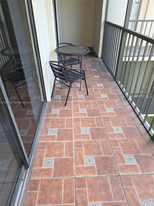 SCREENED BALCONY WITH ACCESS FROM LIVING ROOM AND MASTER BEDROOM