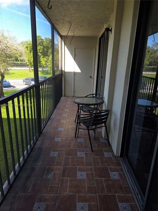 SCREENED , TILED BALCONY WITH STORAGE ROOM