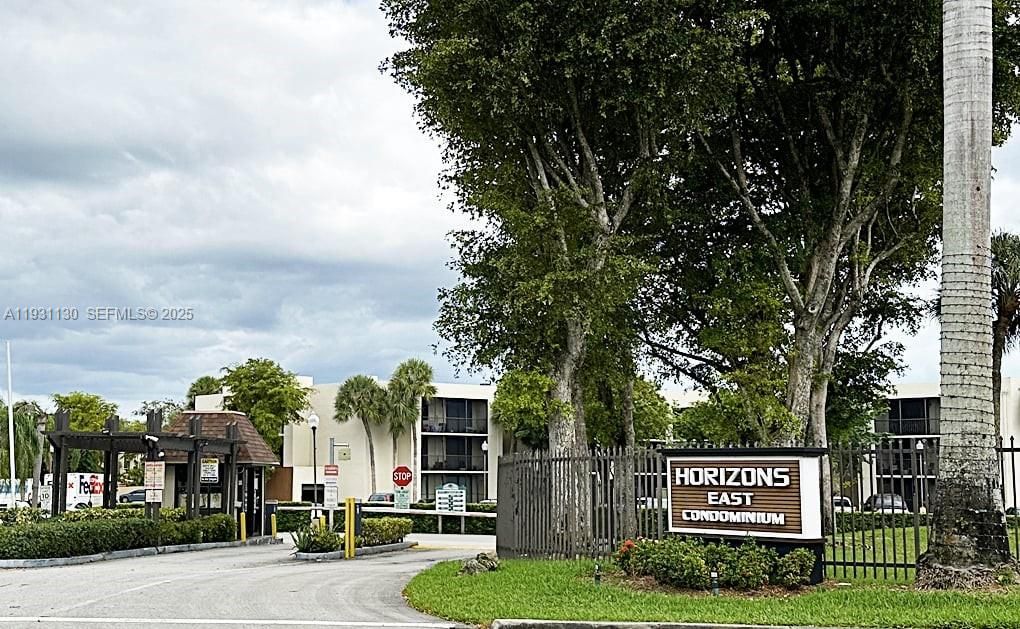 FRONT ENTRANCE TO COMPLEX - GUAR AT GATE