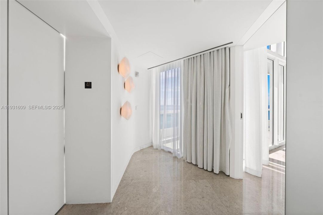 41st floor Private Elevator Foyer with double frosted glass front door opens up to a stunning Living Room with fantastic water views
