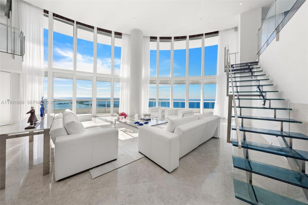 Living Room with custom designed glass and stainless steel staircase