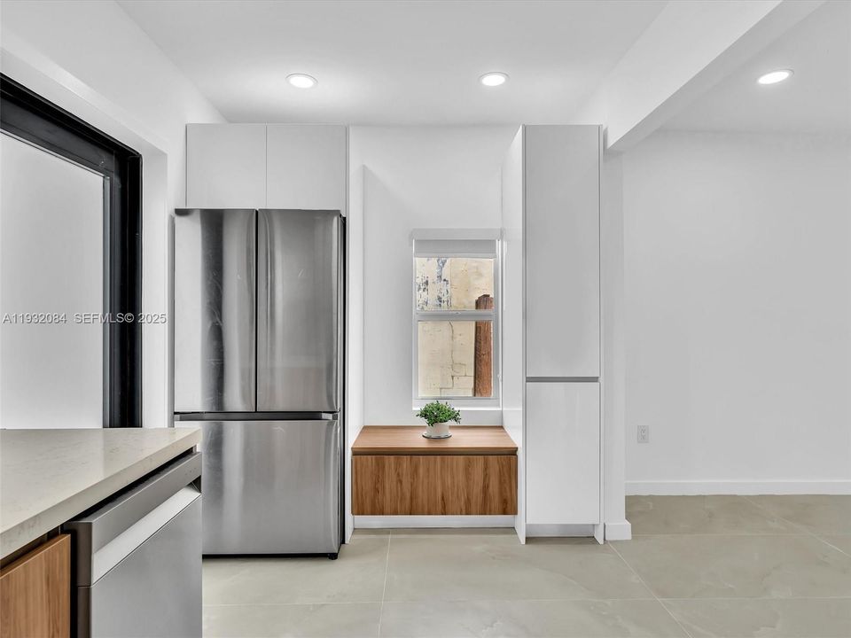 European-style kitchen with quartz counters, stainless steel appliances.