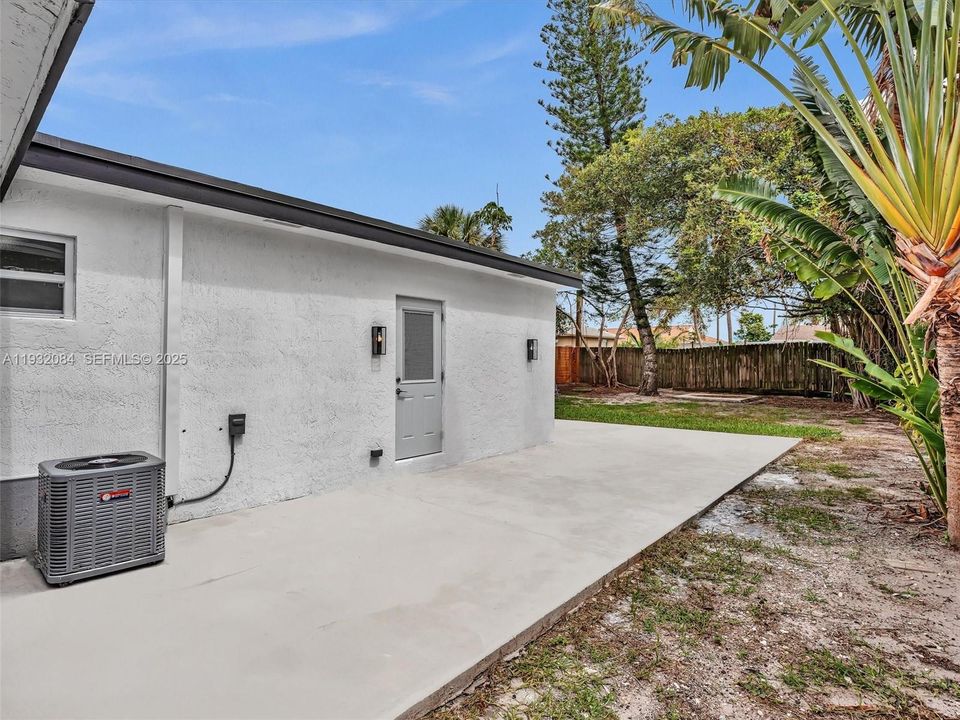 Backyard is ready to create your own oasis. Large Concrete patio surrounding the house.