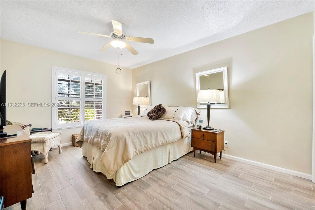 Primary bedroom - impact windows plantation shutters