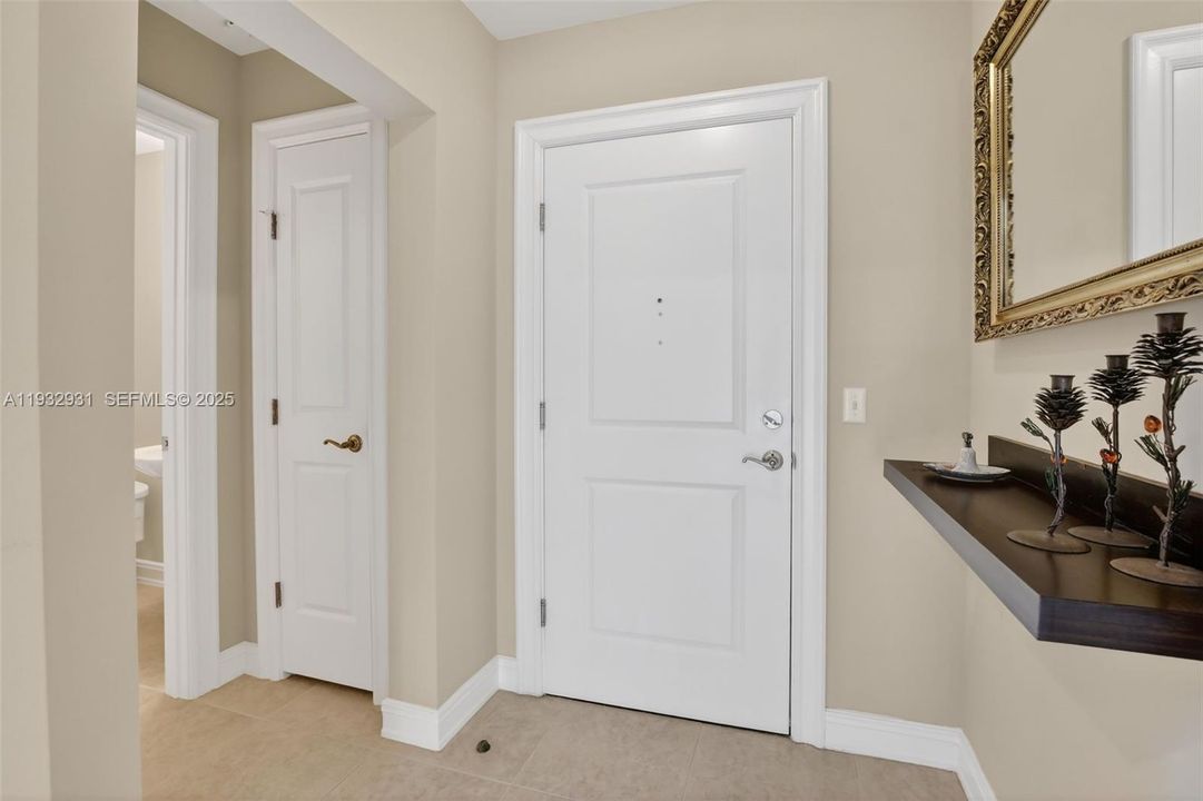 Bright entryway with half bath off right side, hall closet for additional storage