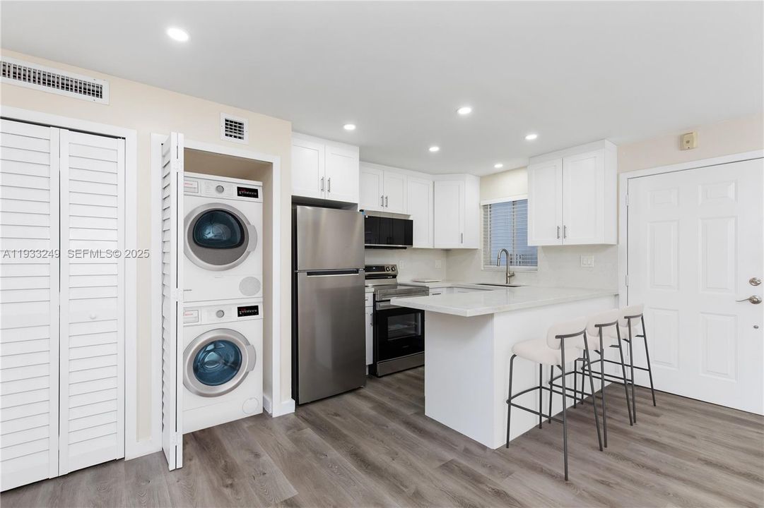 Virtually staged kitchen adding new washer dryer on order.