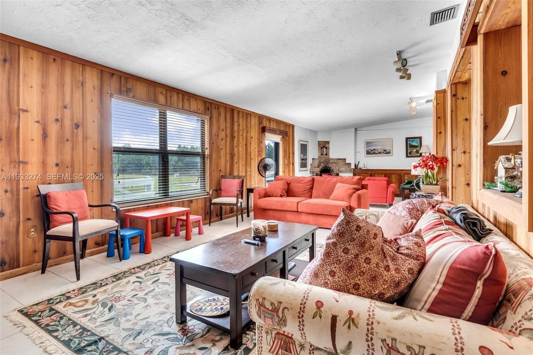 Large Living Area OVERLOOKS THE REAR OF THE PROPERTY WIDE OPEN SPACES AND A GROVE.