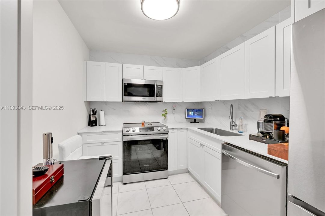 Tastefully remodeled kitchen with plenty of cabinets and a built-in pantry.