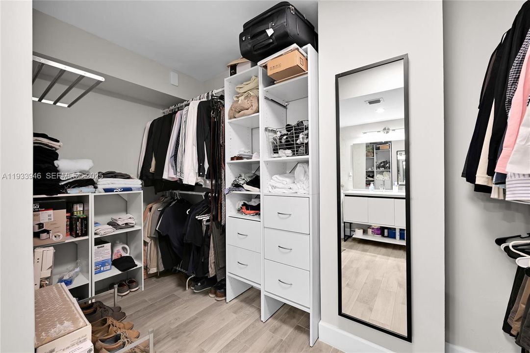 Large primary closet with lots of built-in storage