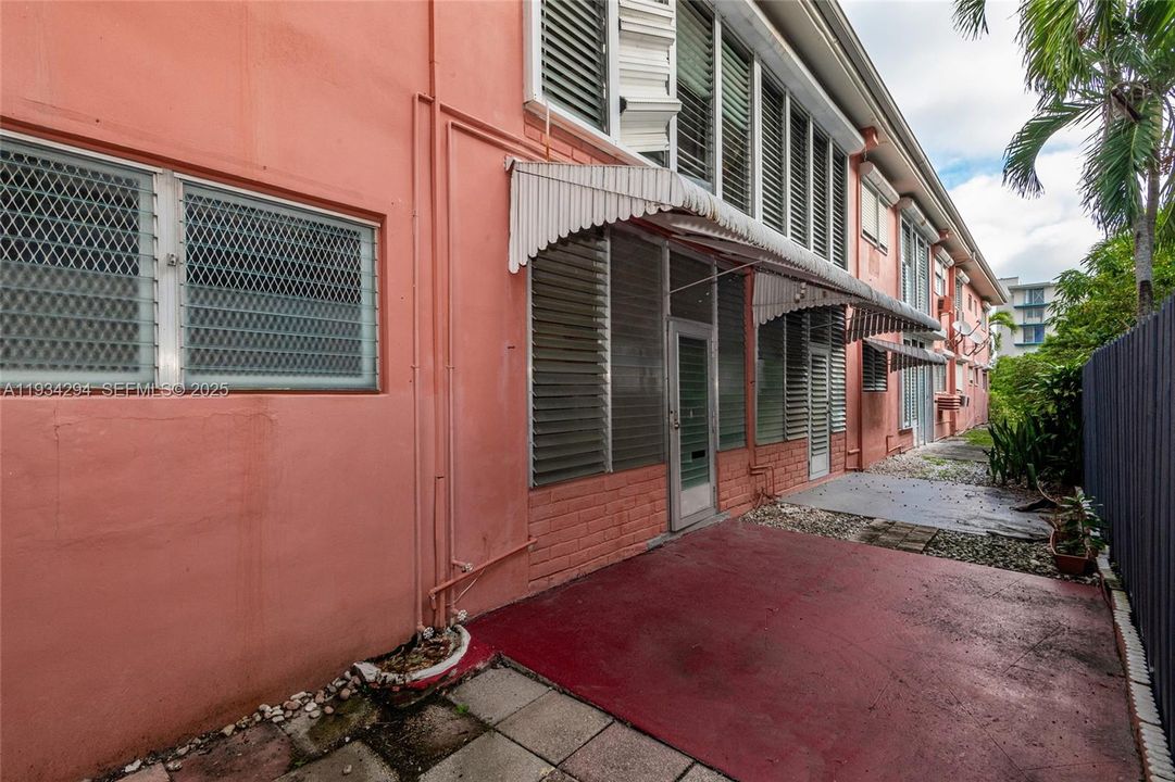 The red concrete area is behind the unit and can be a place to enjoy the evening or morning with your cup of coffee and fresh air.