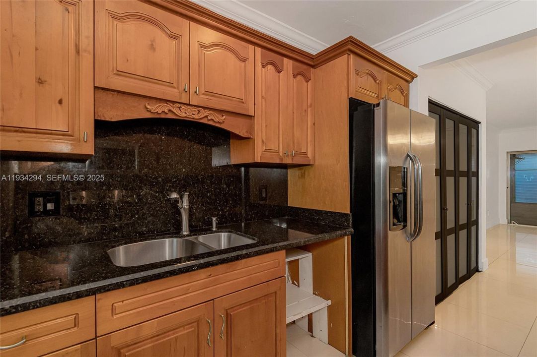 There is a double stainless steel sink, convenient for meal preparation. The black double door closet on the other side of the refrigerator can be storage for groceries and other items.