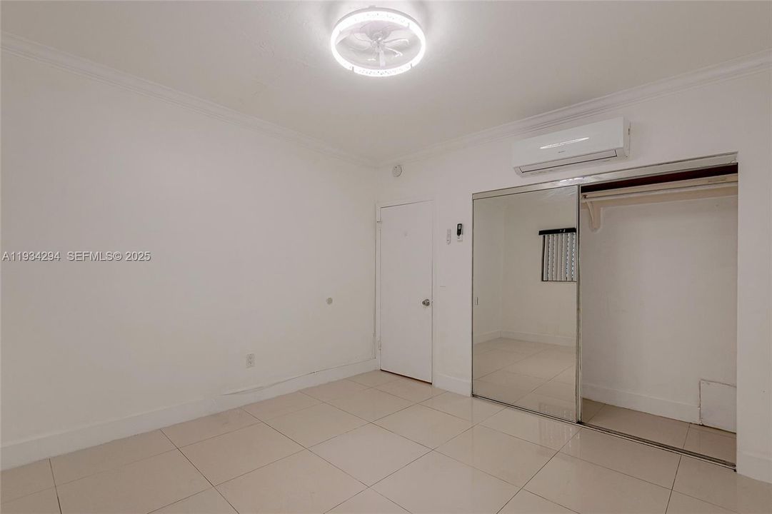 Another view of the front bedroom showing the closet space.