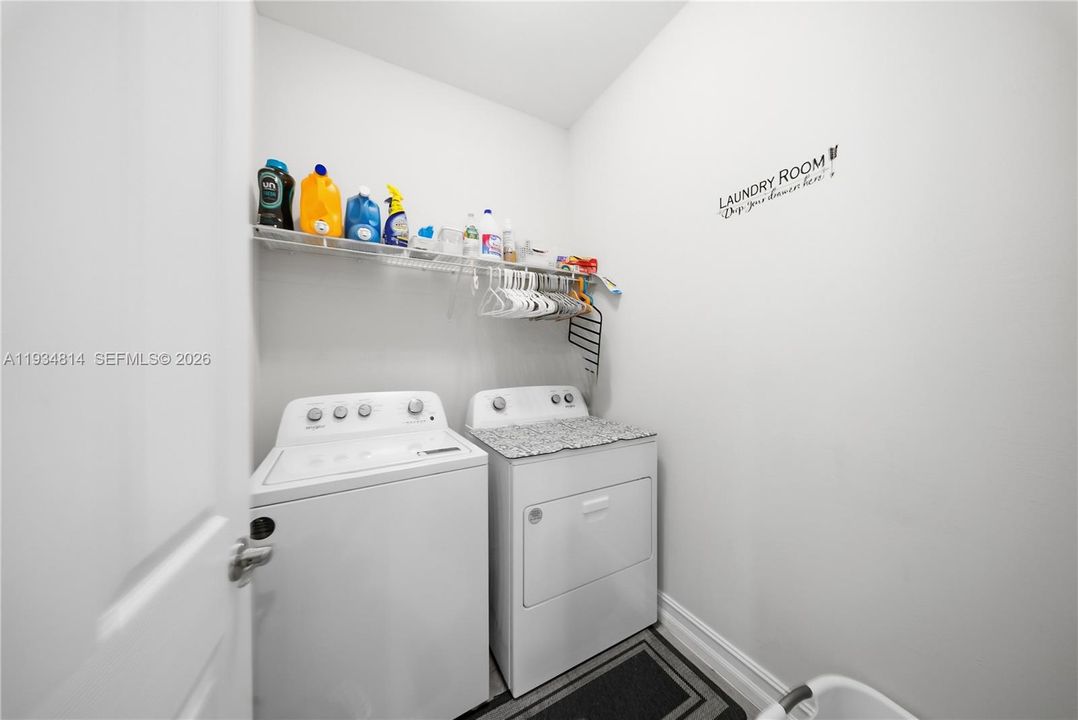 are featuring independent washer and dryer set with baseboard