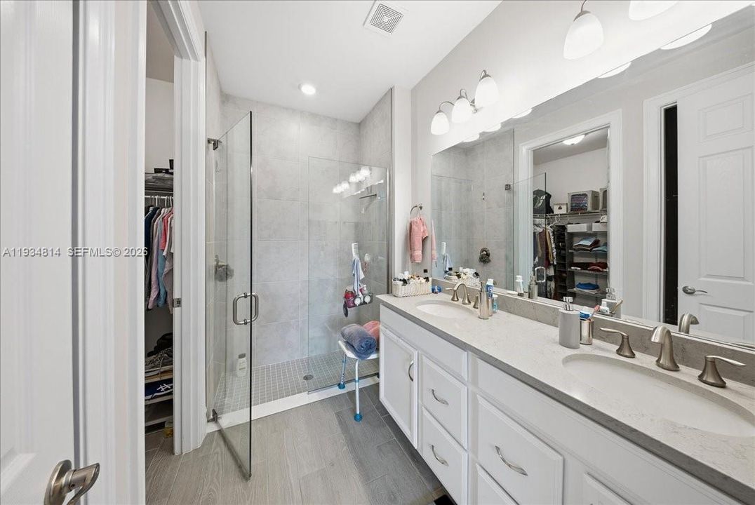 Full master bathroom with walking closet and a stall shower