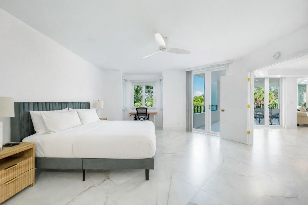 Primary bedroom with balcony view (1)
