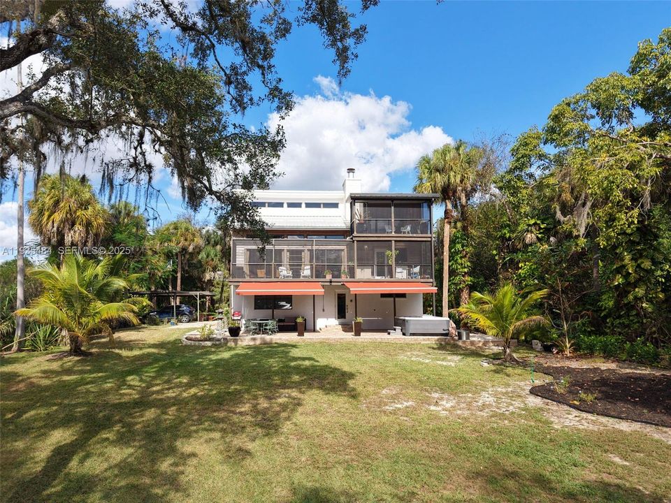 First floor entry from back patio with jacuzzi and sitting area area with river views.