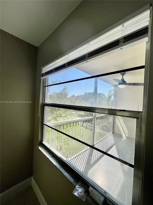 WINDOW VIEW TO BALCONY AND POOL AREA