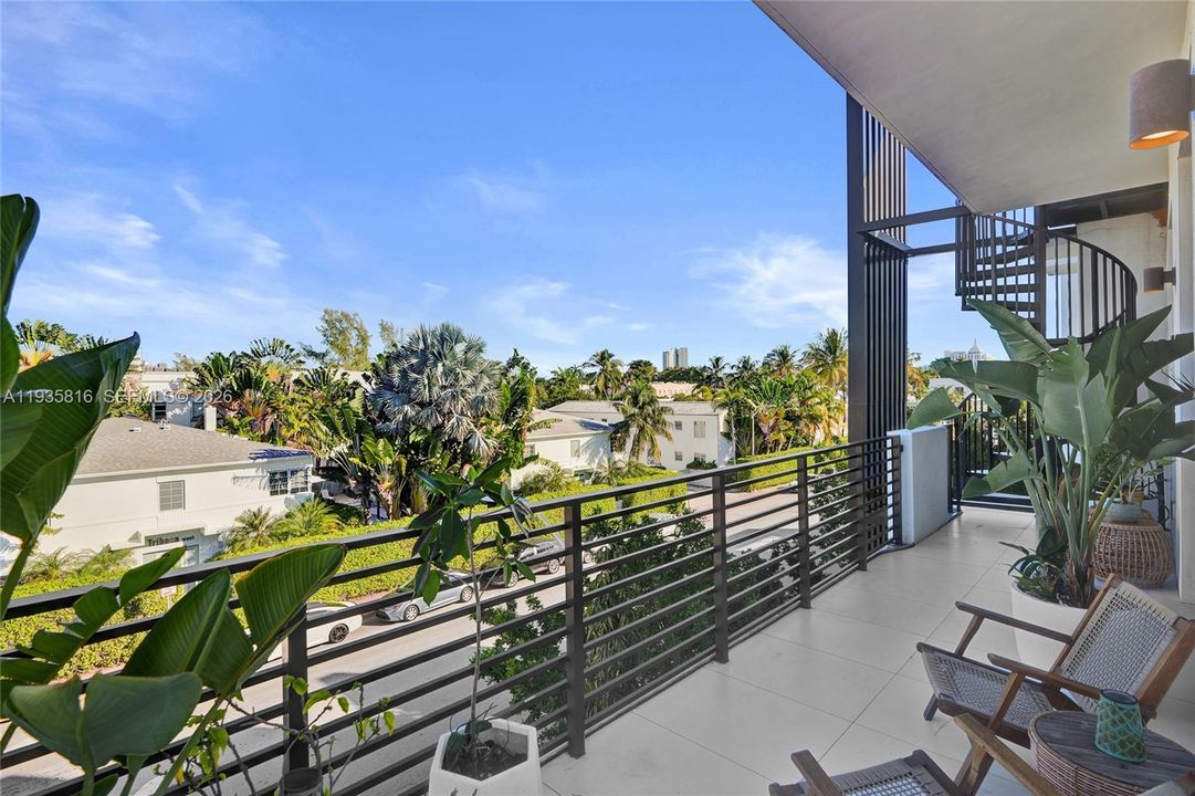 Balcony off living room with spiral stair way to private roof terrace