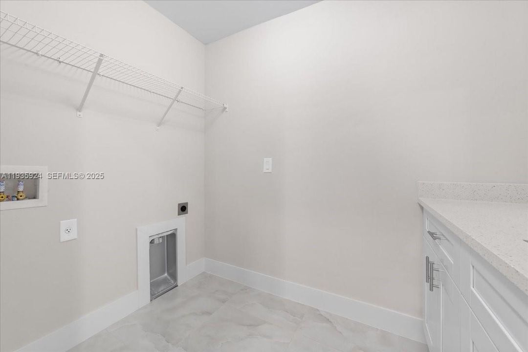 LAUNDRY WITH WASHER AND DRYER. LAUNDRY SINK WITH GRANITE COUNTERTOPS