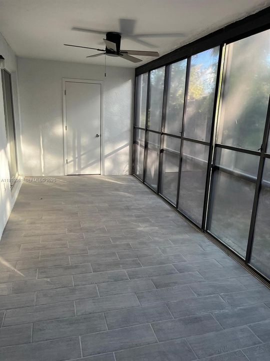 Lanai with newly installed tiles and has a storage closet.