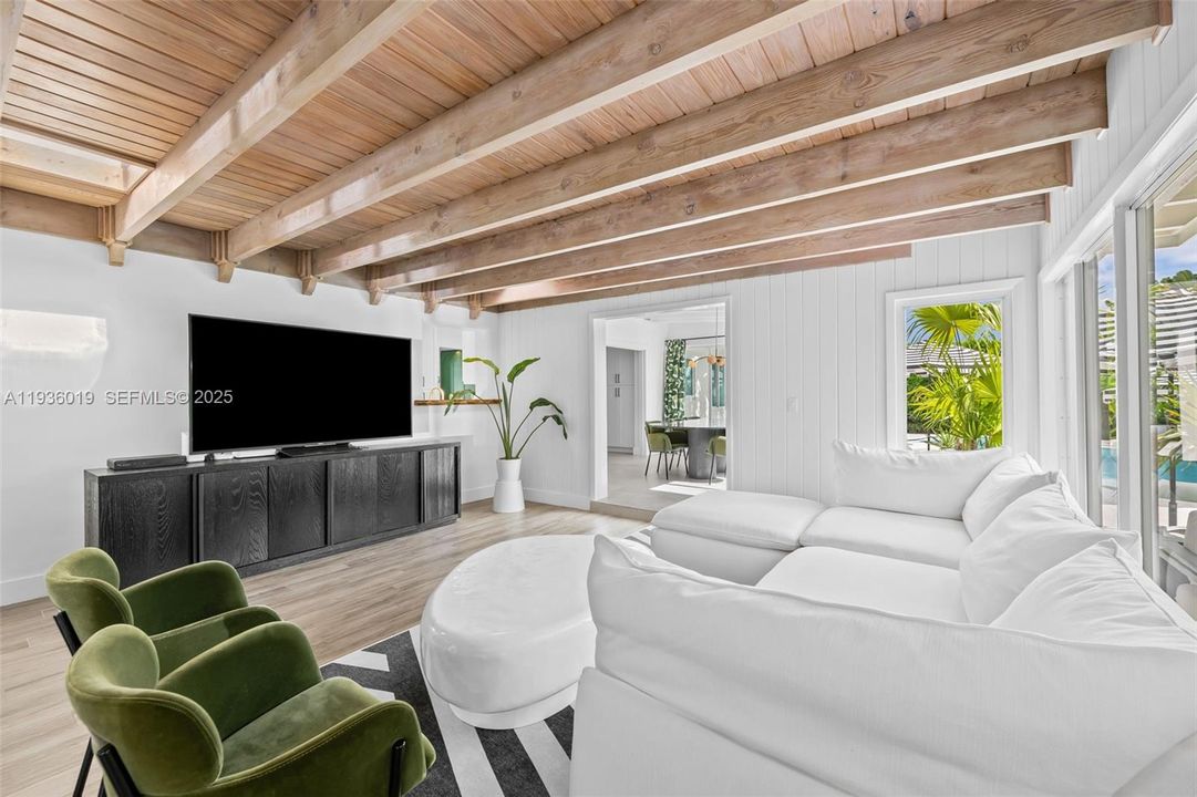 Family room featuring pass thru window to kitchen view to formal dining and outside oasis.