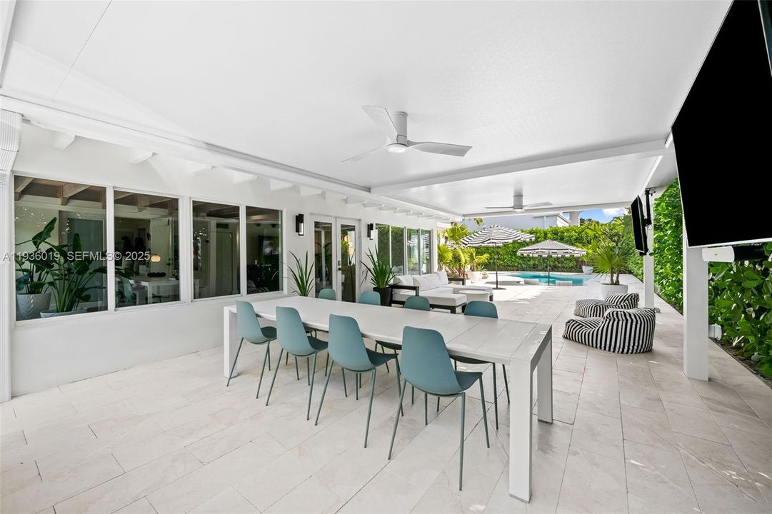 Summer kitchen complete with summer dining and view to pool