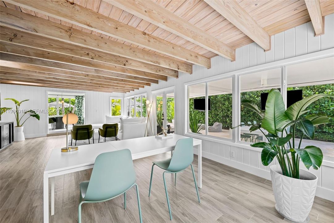View from family room to formal dining. Impact doors leading to summer kitchen & pool.