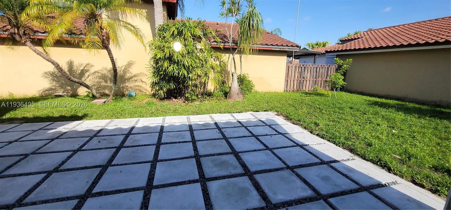 patio area with plenty of new green grass.