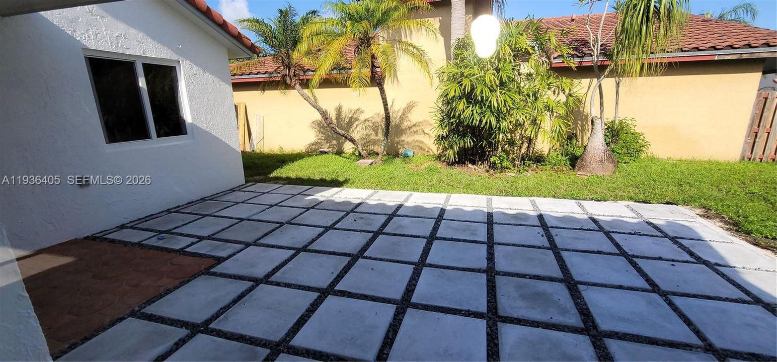 patio area with plenty of new green grass.