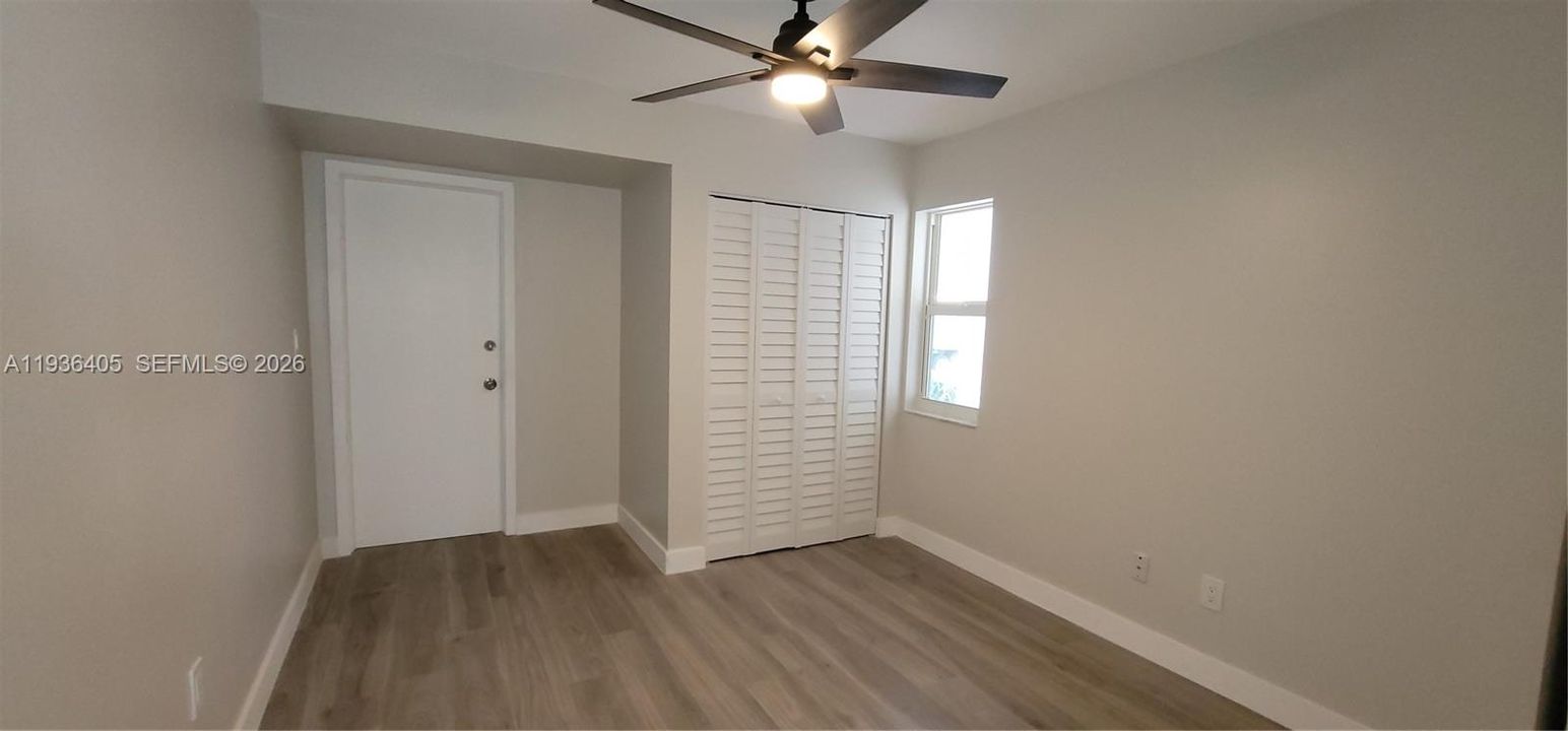 Garage has been converted into a den with a window and a closet. Door connects to main garage door which opens to a small storage area for bikes or gardening tools, etc.