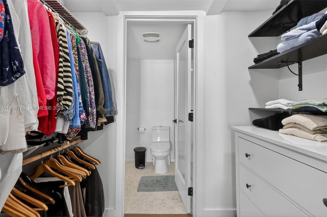 Closet leading to primary bathroom