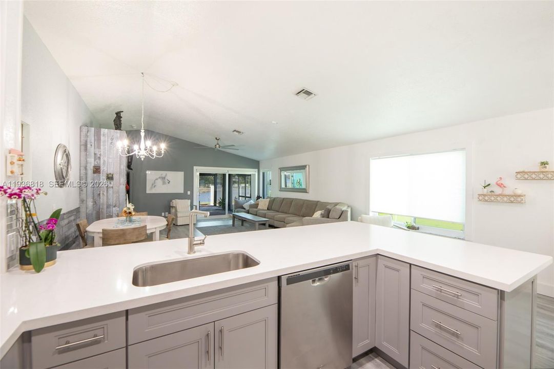Open floor concept. Quartz Countertops w shaker light grey cabinets