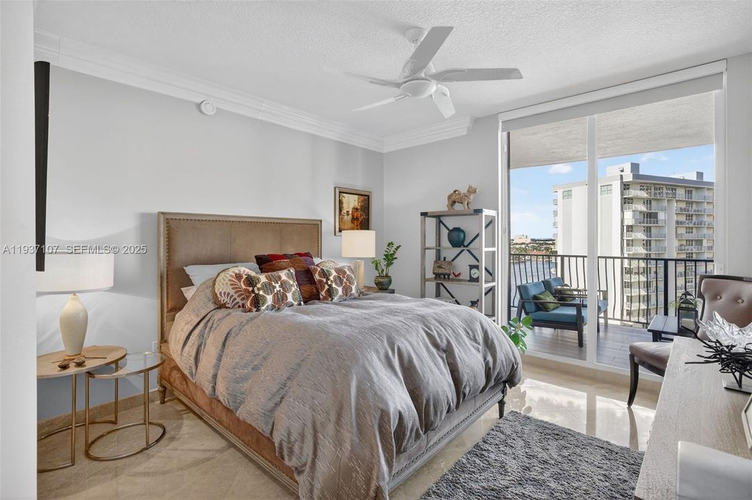Guest bedroom (2nd primary bedroom) w/ sliders off to the balcony and intracoastal views & motorized window roller shade.