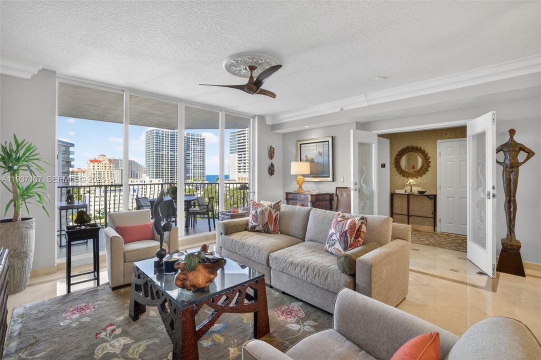 Marble flooring, ocean views, floor to ceiling glass, crown molding. Bright open and airy.