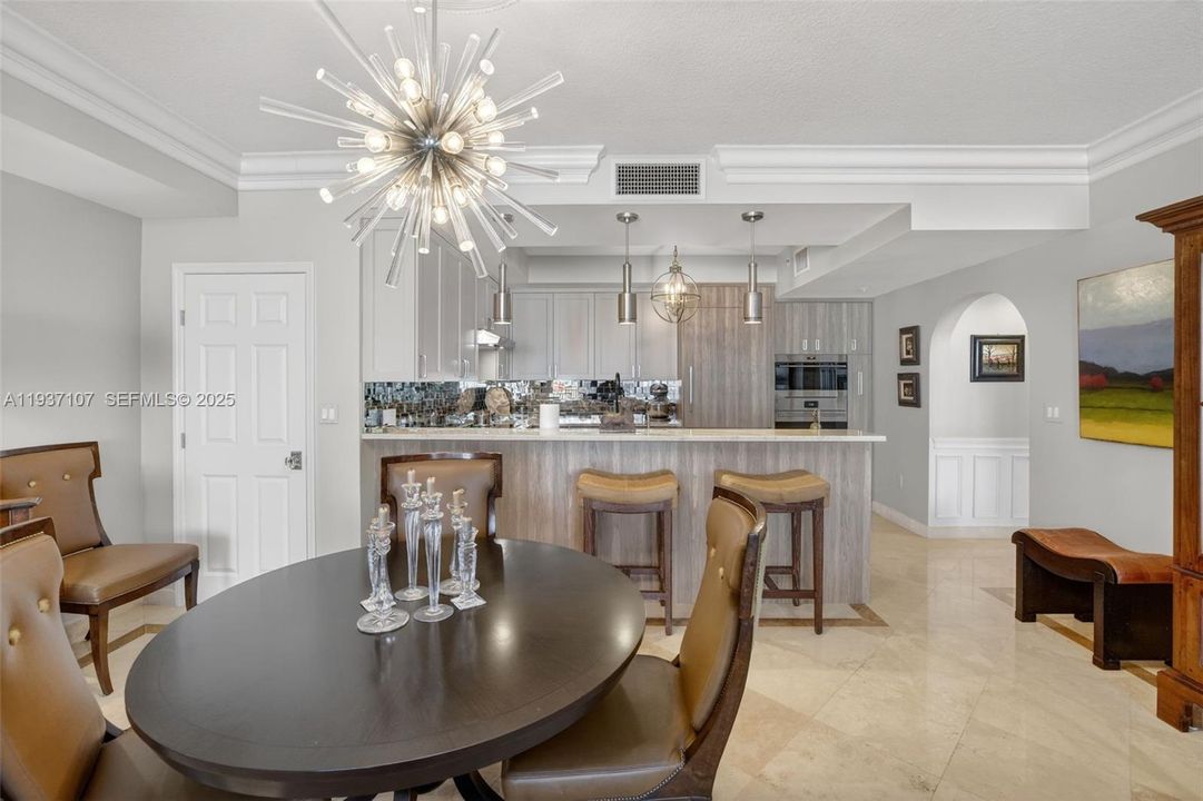 Beautiful sputnik chandelier, Storage closet (w/ Emtek crystal door hardware throughout unit), counter seating at kitchen. Crown molding.