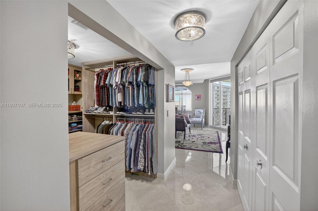 Custom walk in primary closet w/ secondary custom closet behind doors