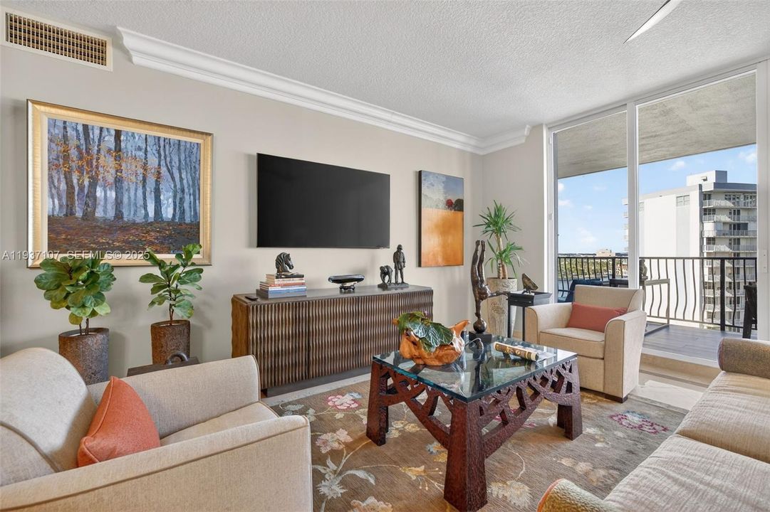 Marble flooring, water views, floor to ceiling glass, crown molding. Bright open and airy.