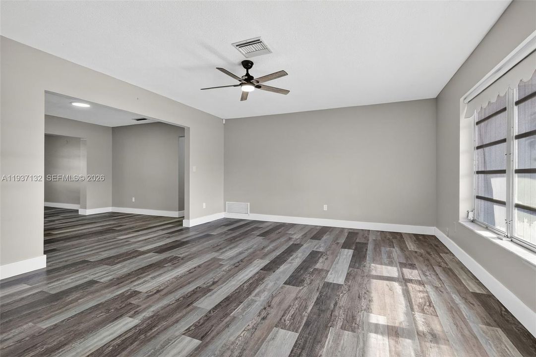 ONE OF 2 LIVING ROOMS THE DOOR IS THE FRONT ENTRANCE