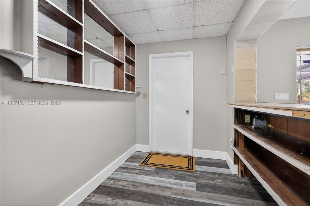 BEHIND THE BUILT IN BAR AND THE DOOR TO THE CABANA BATHROOM