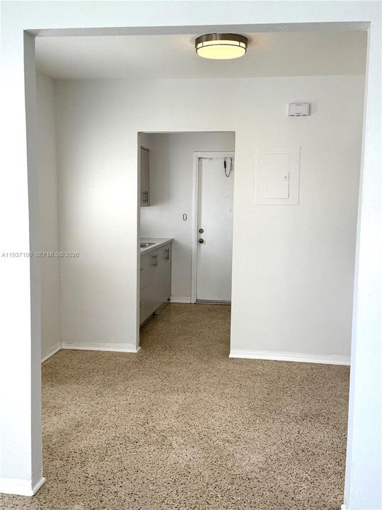 View of dining and kitchen  from living area.West facing exit.