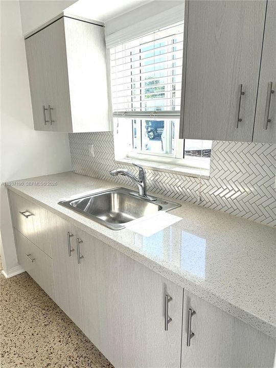 Updated cabientry quartz counter tops , tile back splash and new appliances.  South view.