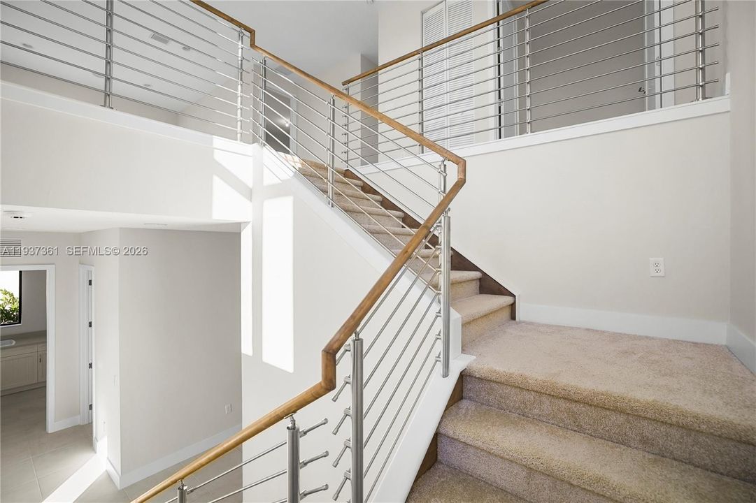 Entry foyer featuring contemporary cable-railed staircase