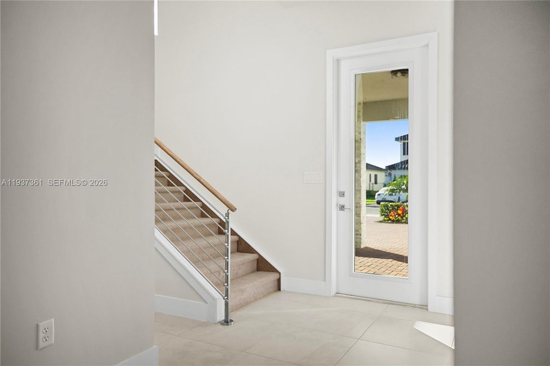 Entry foyer featuring contemporary cable-railed staircase