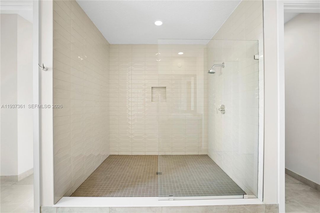 Oversized walk-in shower with floor-to-ceiling tile